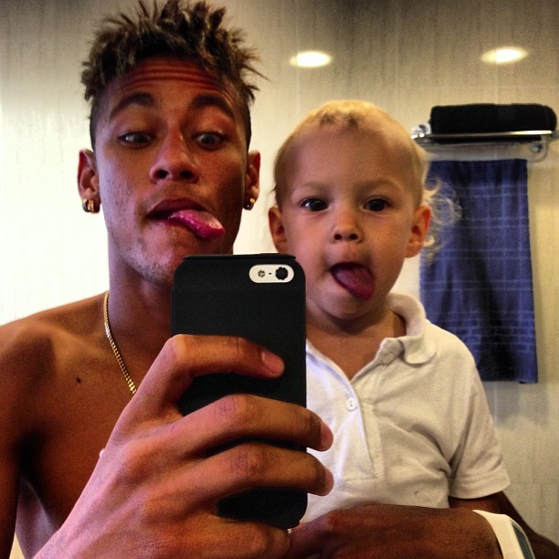 Neymar and David Lucca, sticking their tongues out and taking a photo picture