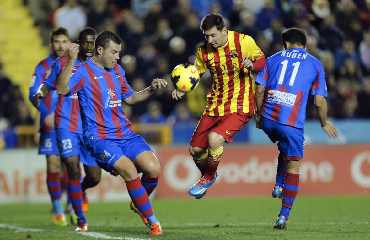 Lionel Messi battling against several defenders