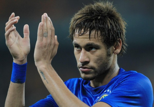 Neymar clapping his hands in a Brazil blue jersey