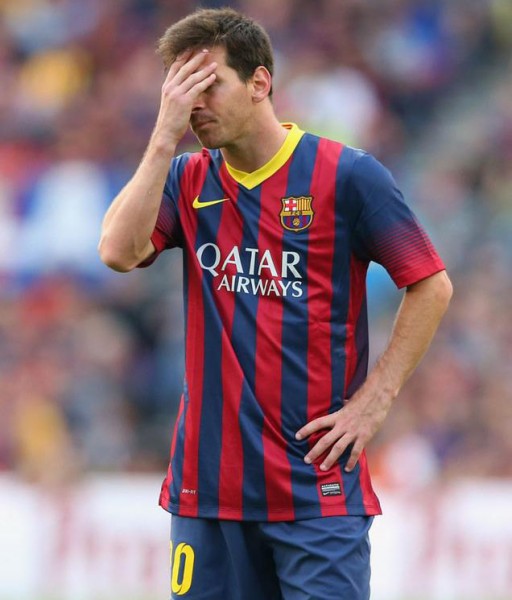 Messi covering his face in shame