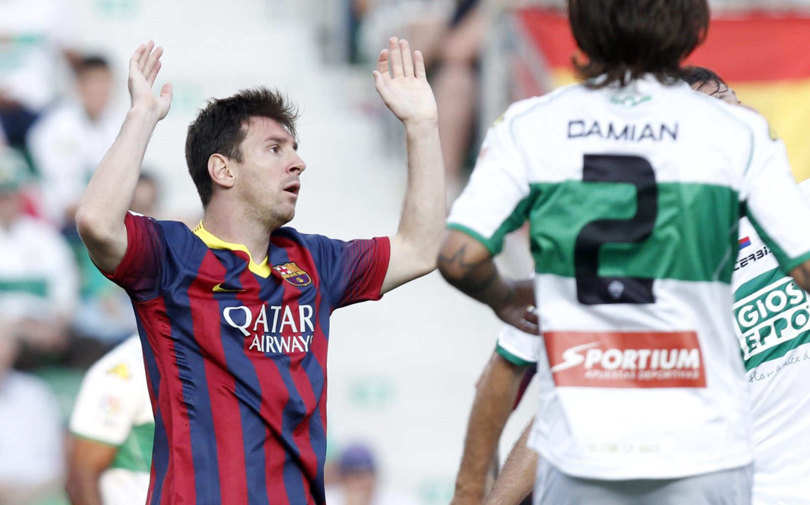 Messi raising his two arms to the air