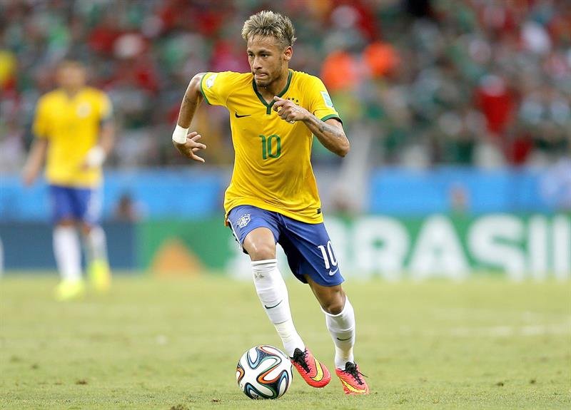 Neymar racing with the ball glued to his foot, in the FIFA World Cup 2014