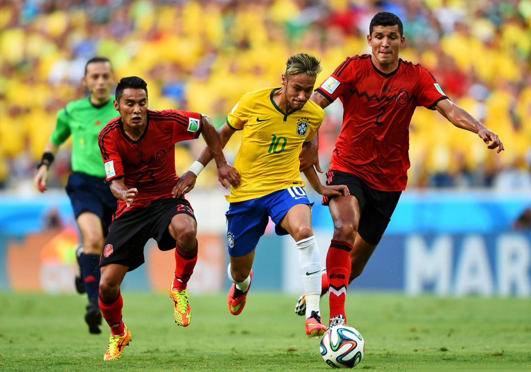 Neymar running away from 2 defenders in the FIFA World Cup 2014