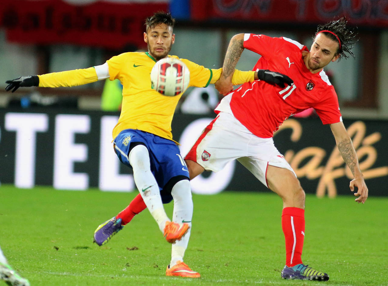 Neymar attempting to keep the ball in his control in Austria vs Brazil