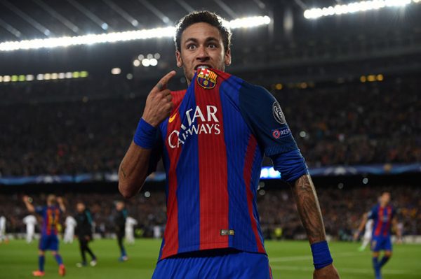 Neymar bites his shirt and points to Barcelona badge