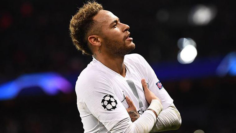 Neymar playing for PSG in a white shirt