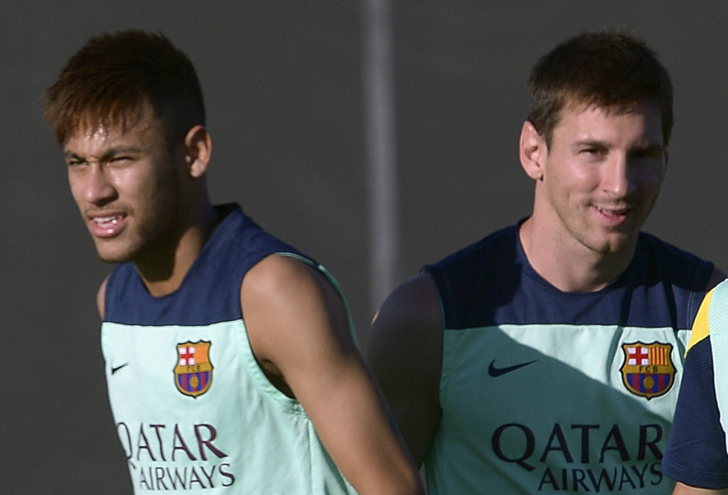 Neymar and Lionel Messi smiling in training