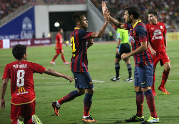 Neymar celebrating his first goal for Barcelona, with Fabregas