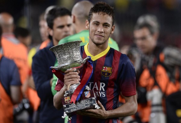 Neymar holding his first trophy won at Barcelona, in 2013