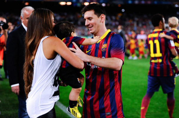 Lionel Messi and his girlfriend Antonella Roccuzzo, holding their son at the Camp Nou