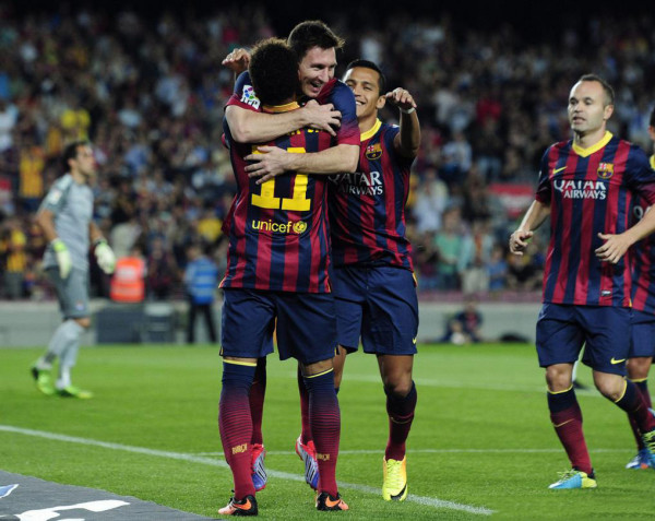 Lionel Messi jumping in Neymar's direction, to hug him and thank him for the assist