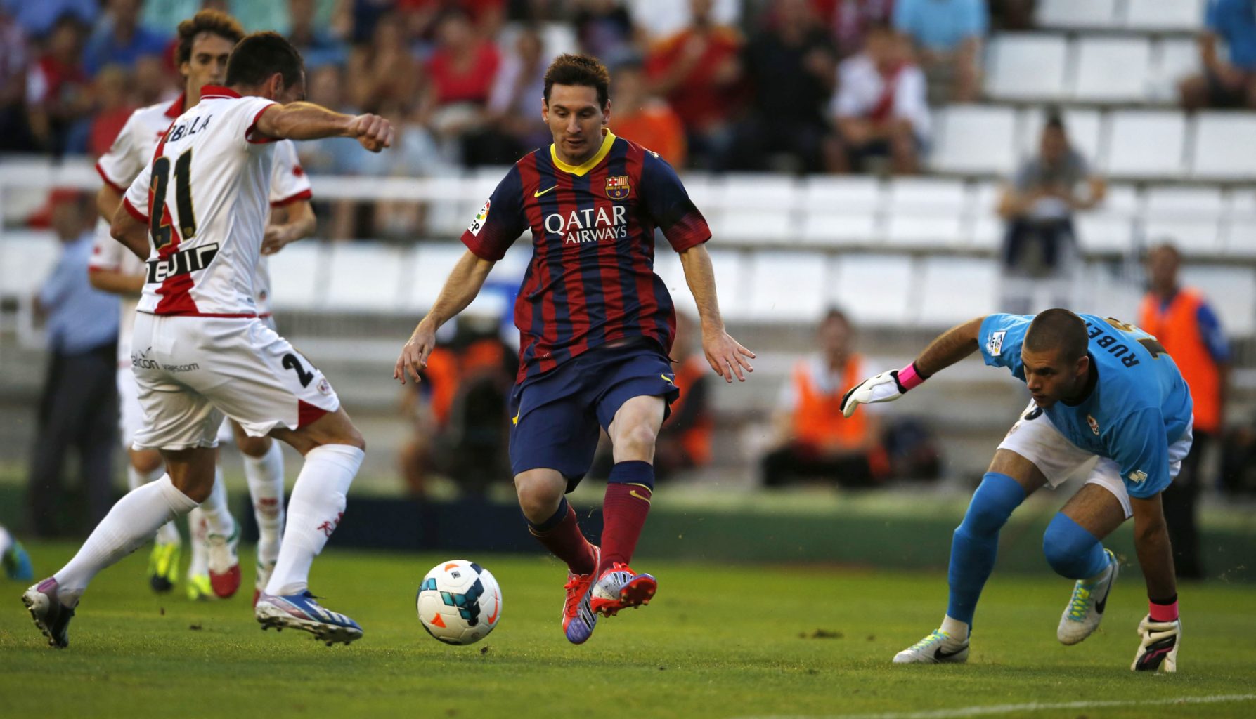 Lionel Messi surrounded by Rayo defenders