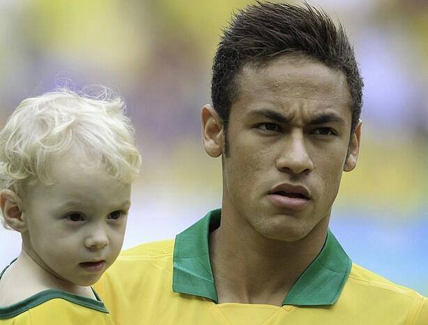 Neymar and his son David Lucca on the pitch, ahead of a Brazil international match