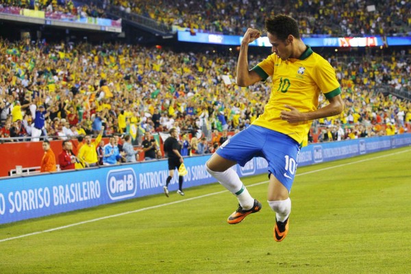 Neymar jumping to celebrate his goal for Brazil against Portugal, in 2013