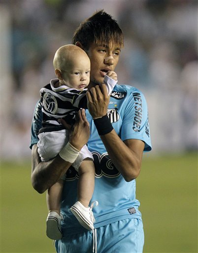 Neymar taking his son to the pitch, in Brazil