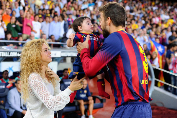 Shakira and Gerard Piqué, taking their son and daughter Milan, to a Barcelona game in 2013