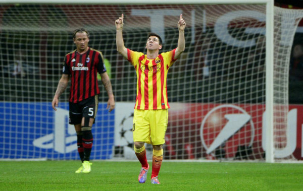 Lionel Messi pointing to the sky, as he celebrates Barcelona goal against Milan