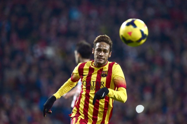 Neymar chasing the ball in a Barcelona red and yellow stripes jersey