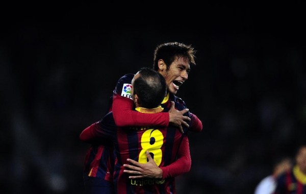 Neymar jumping and hugging Iniesta