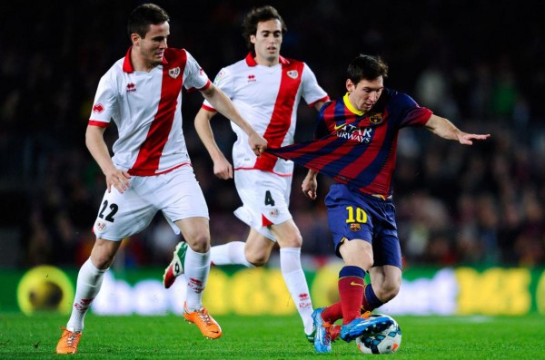 Messi being hold by his shirt, as he gets past a defender
