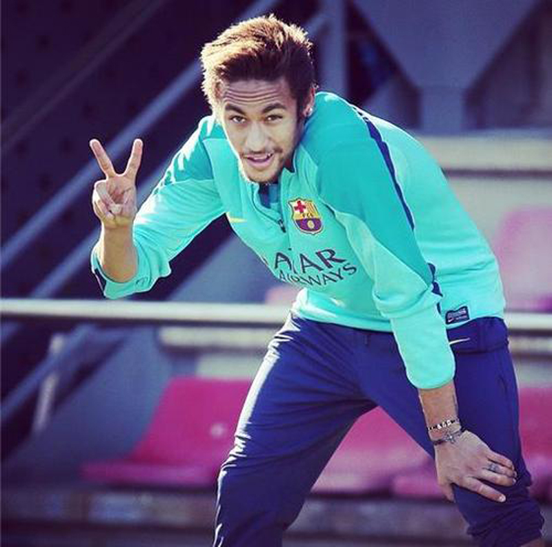 Neymar making the victory gesture, with his fingers