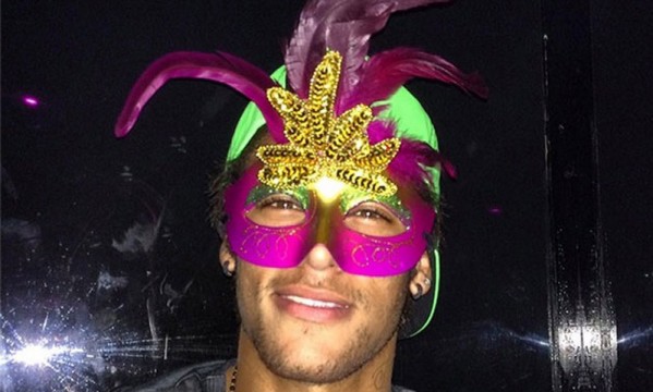 Neymar poses to the cameras with a Brazilian Carnival mask