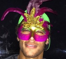 Neymar poses to the cameras with a Brazilian Carnival mask