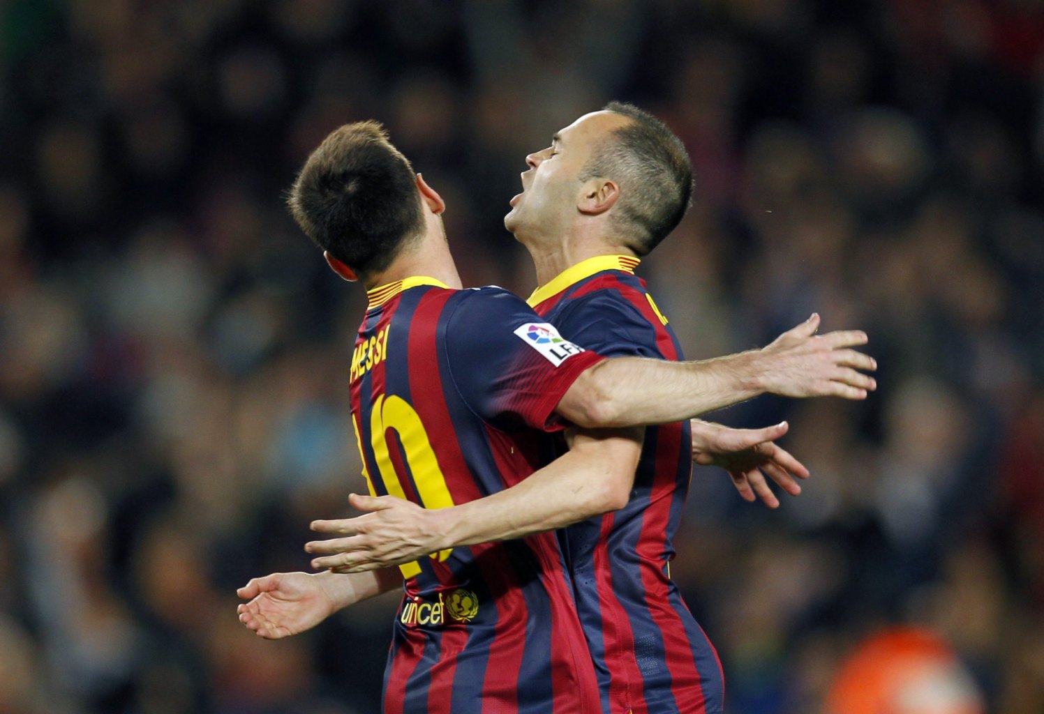 Lionel Messi and Andrés Iniesta clashing their chests