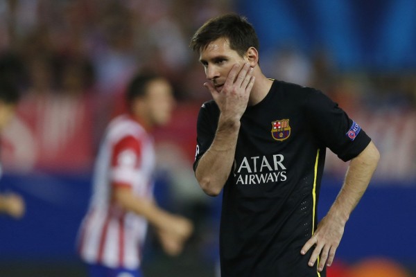Lionel Messi putting his hand on his face