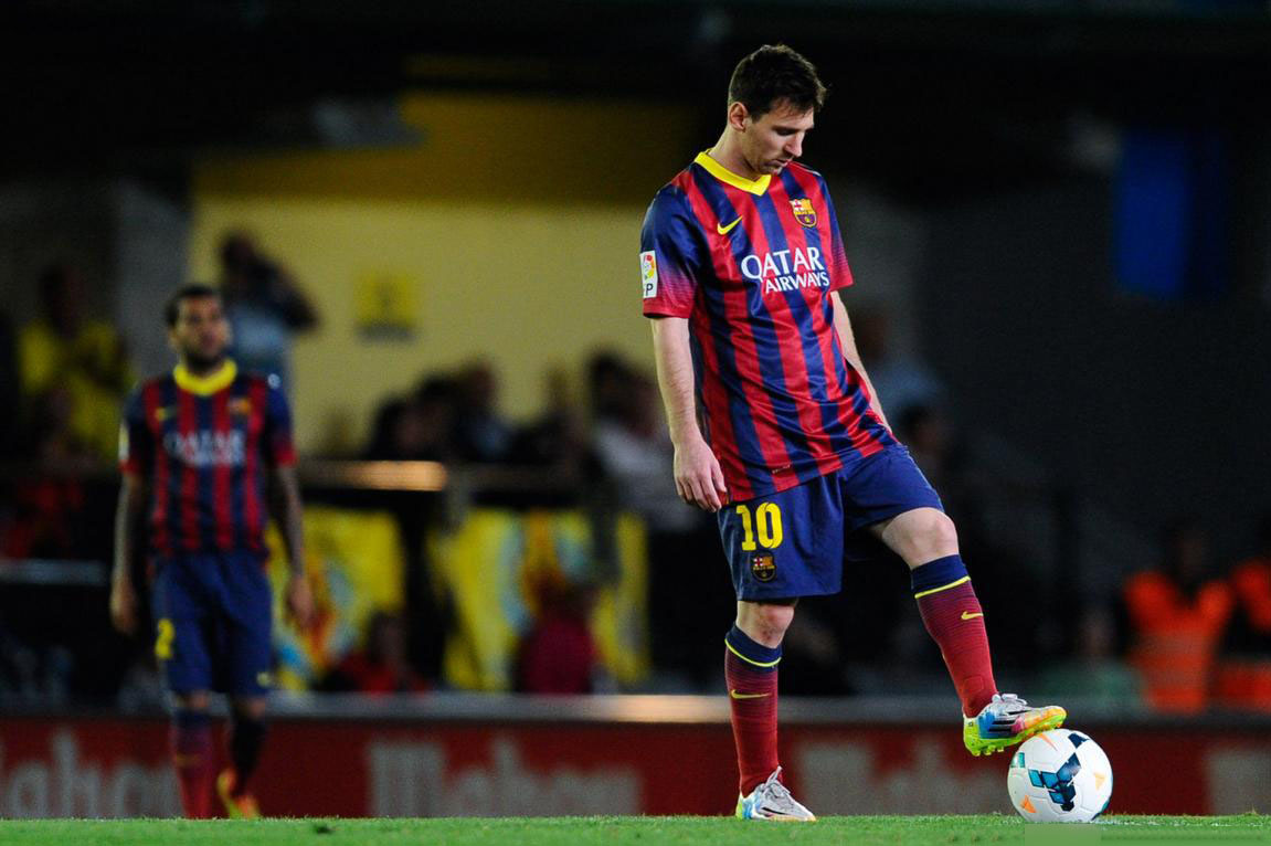Lionel Messi waiting to resume the game in t he midfield line