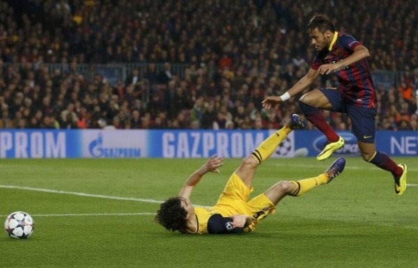 Neymar jumping over a defender, during a Barcelona vs Atletico Madrid game