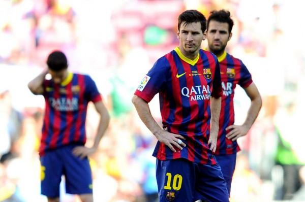 Lionel Messi and Fabregas looking disappointed in Barcelona