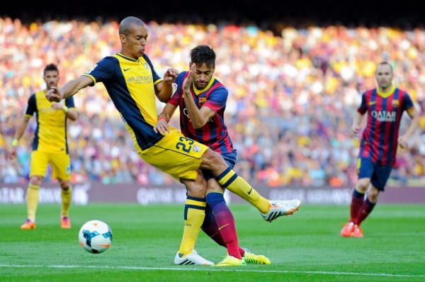 Miranda tackling Neymar, in Barcelona vs Atletico