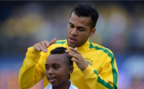 Daniel Alves combing a little kid's hair