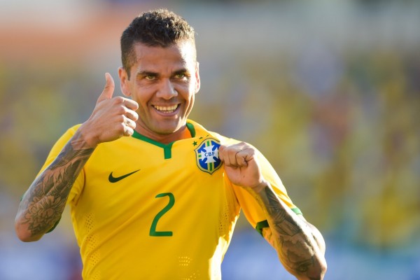 Daniel Alves holding the Brazil badge