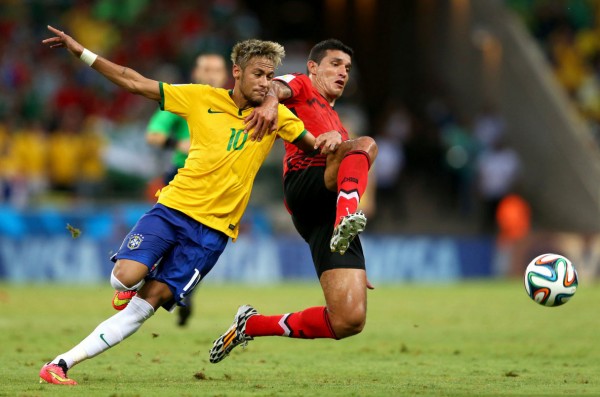 Neymar challenging for a loose ball, in Brazil 0-0 Mexico, at the FIFA World Cup 2014