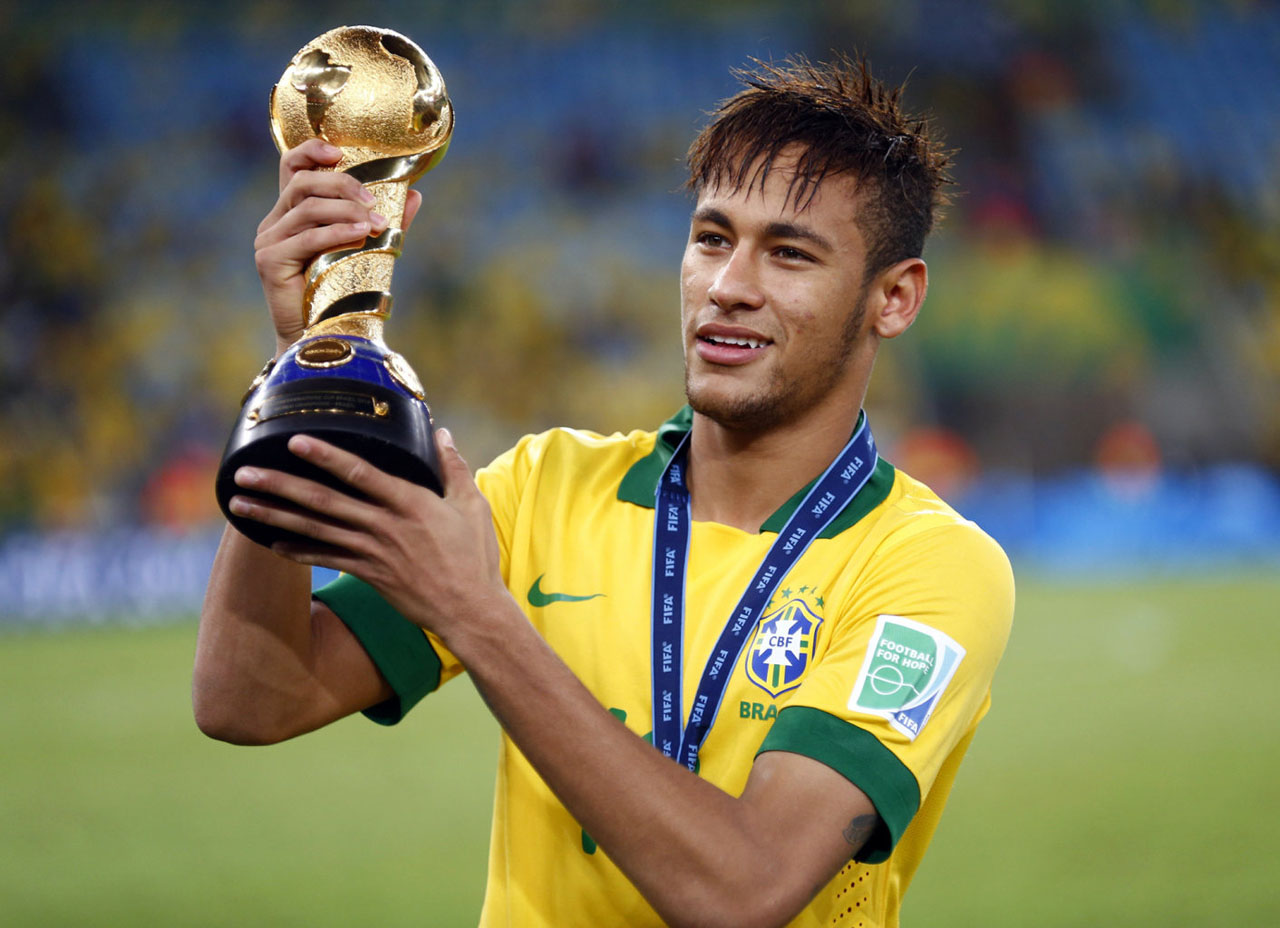 Neymar holding a small World Cup trophy