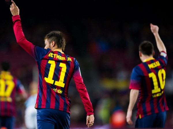 Neymar and Messi raising their hands up in the air