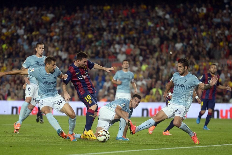 Lionel Messi in the middle of a crowd of opponents