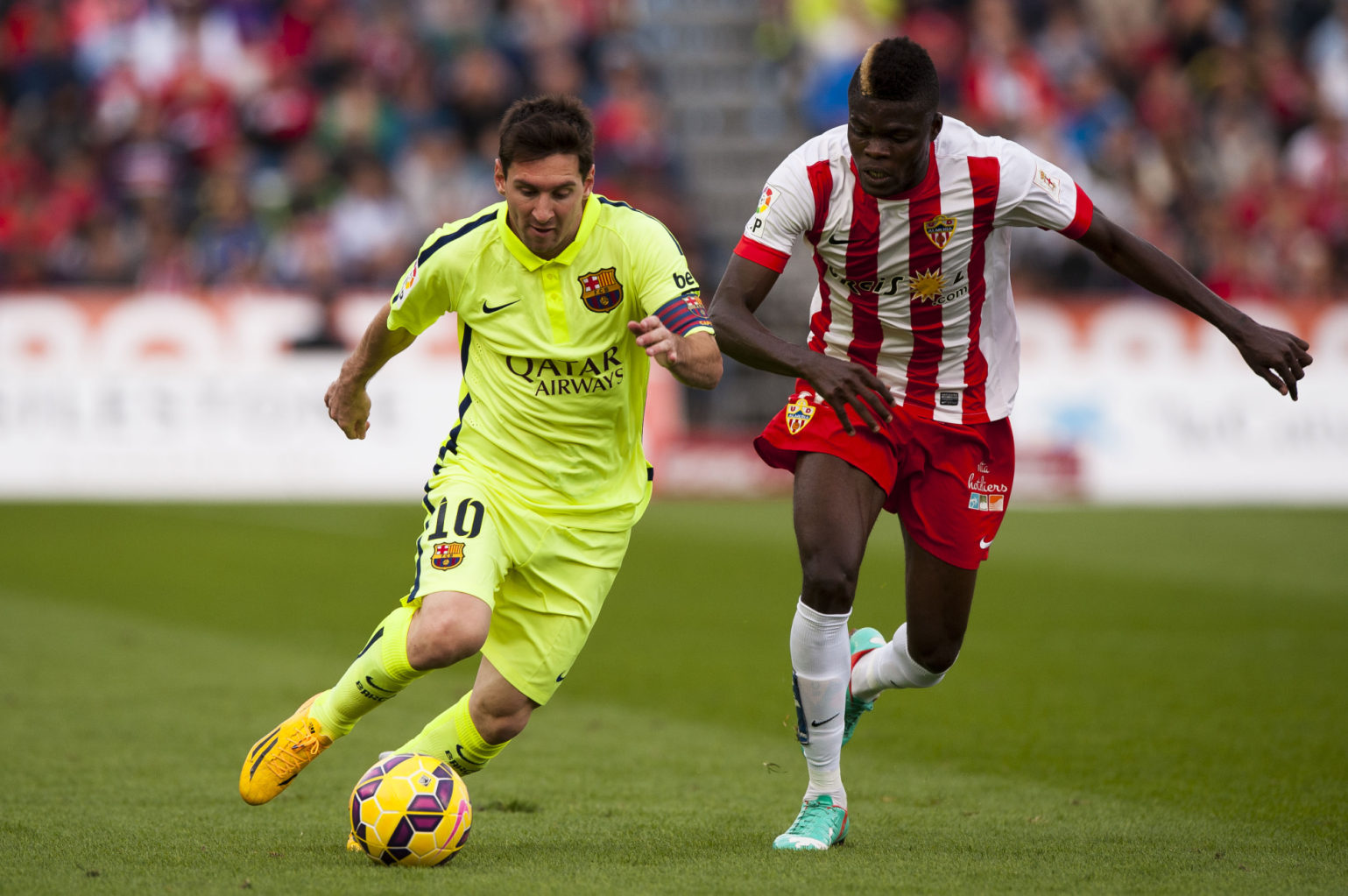 Lionel Messi running past a defender in Almeria vs Barcelona