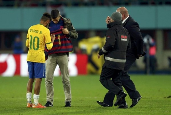 Neymar signing an autograph to a pitch invader in Austria vs Brazil