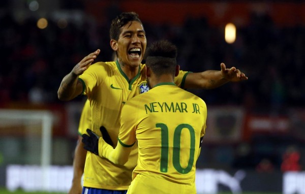 Roberto Firmino celebrating Brazil's winning goal with Neymar