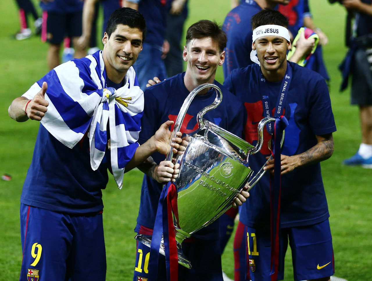 Suarez, Messi and Neymar holding the UEFA Champions League trophy in 2015