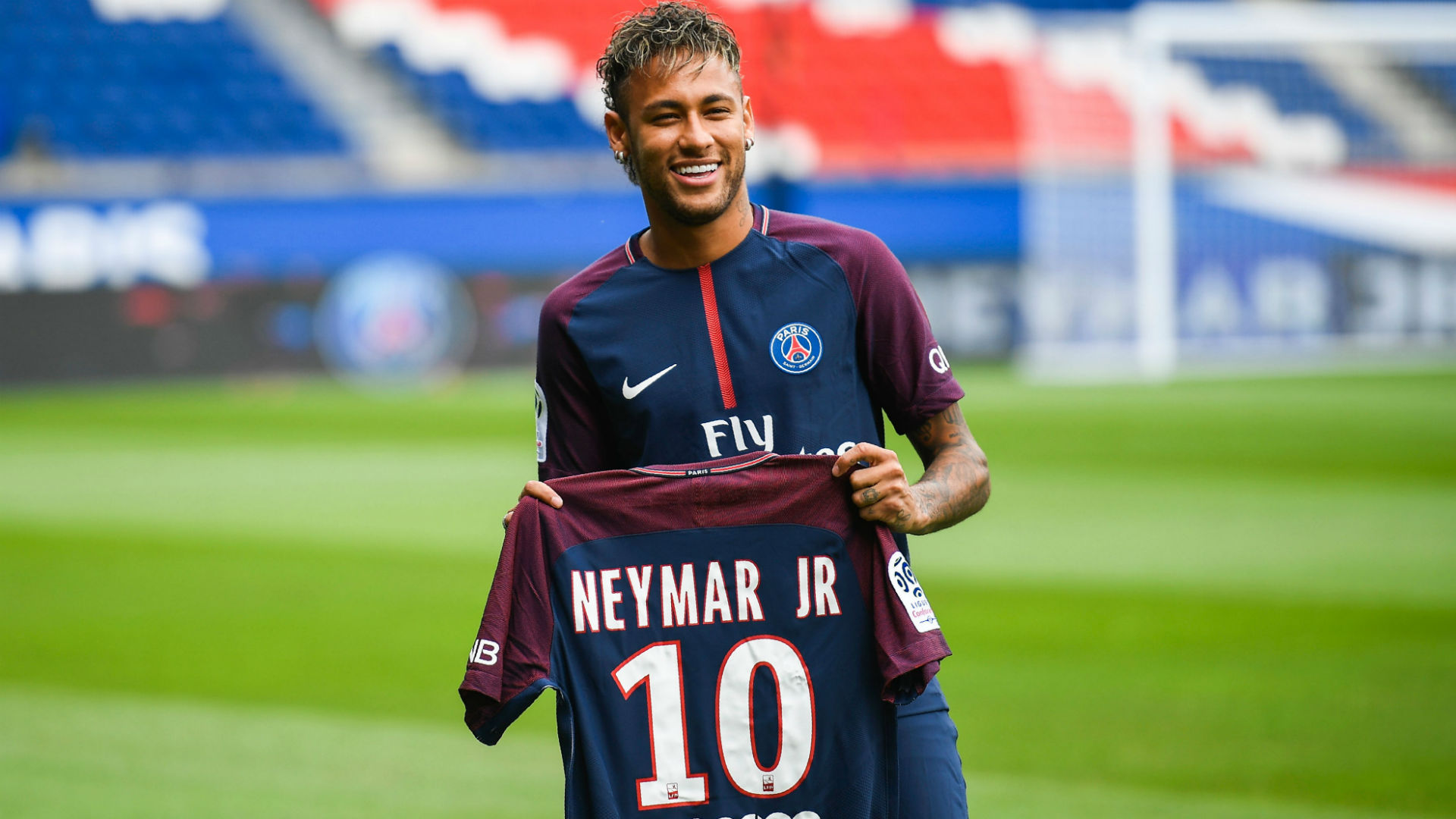 Neymar holding his PSG number 10 shirt