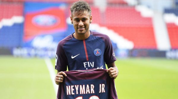 Neymar Jr holding his PSG jersey